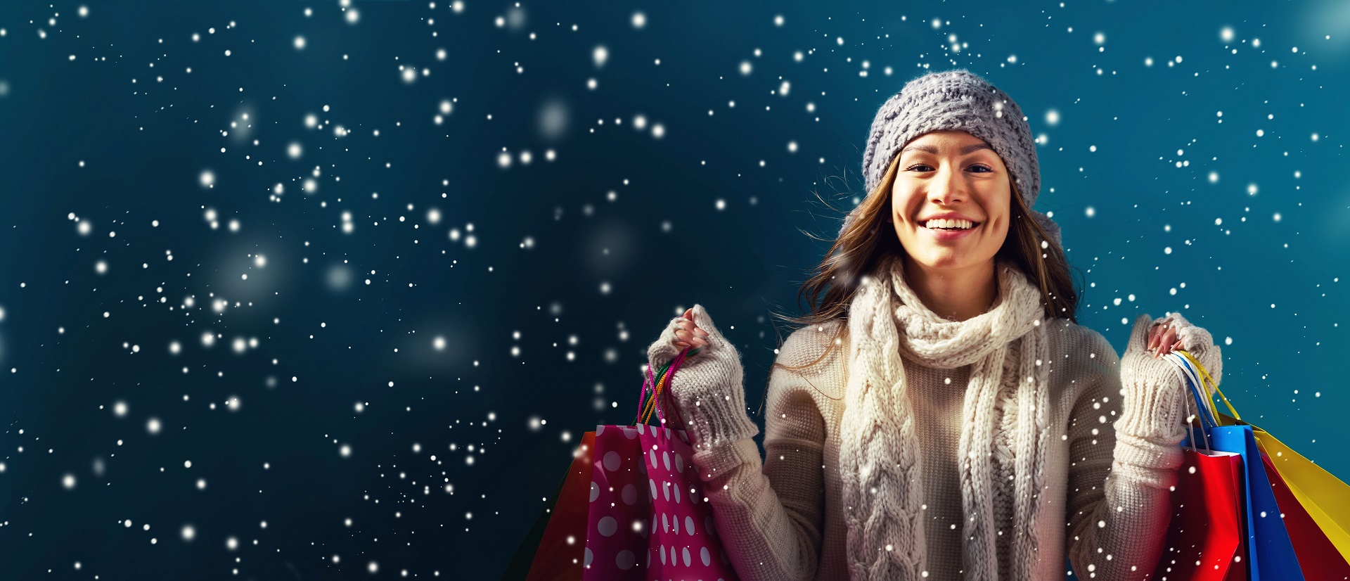 Happy young woman holding shopping bags